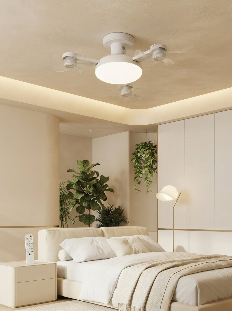 A modern white ceiling fan light installed on a warm cream ceiling in a minimalist room with soft golden ambient lighting.