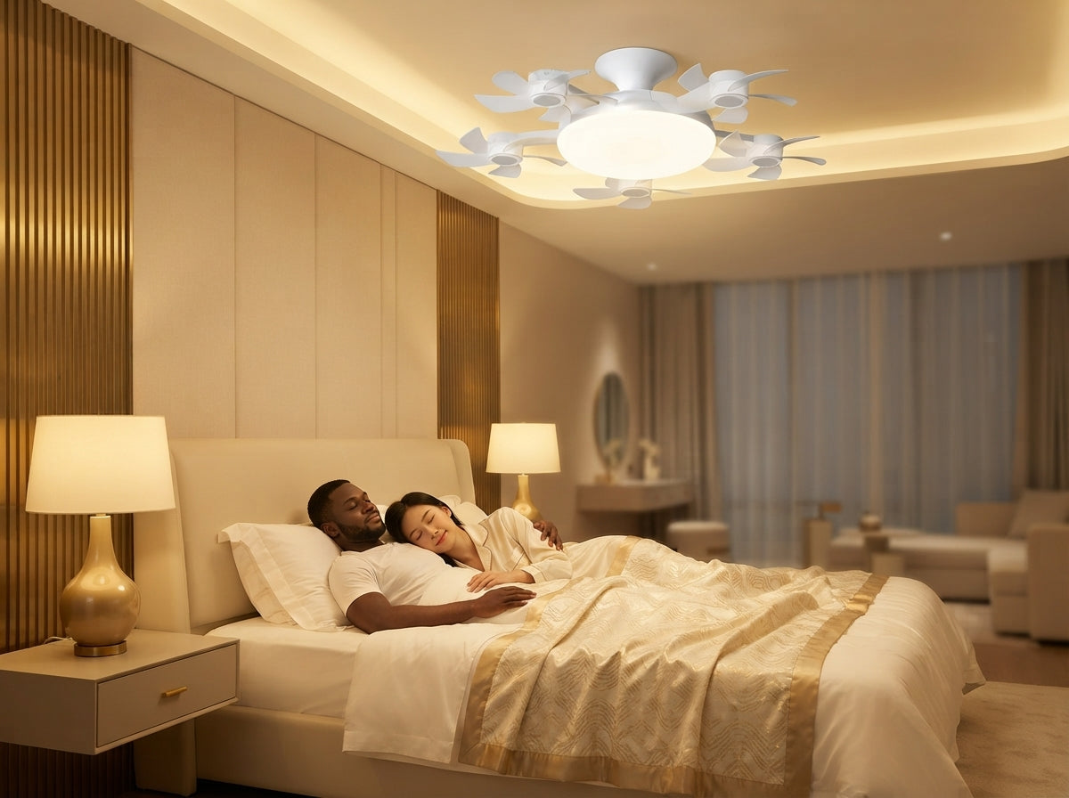 A couple relaxing in a modern, serene bedroom under a sleek, silent LED ceiling fan light.